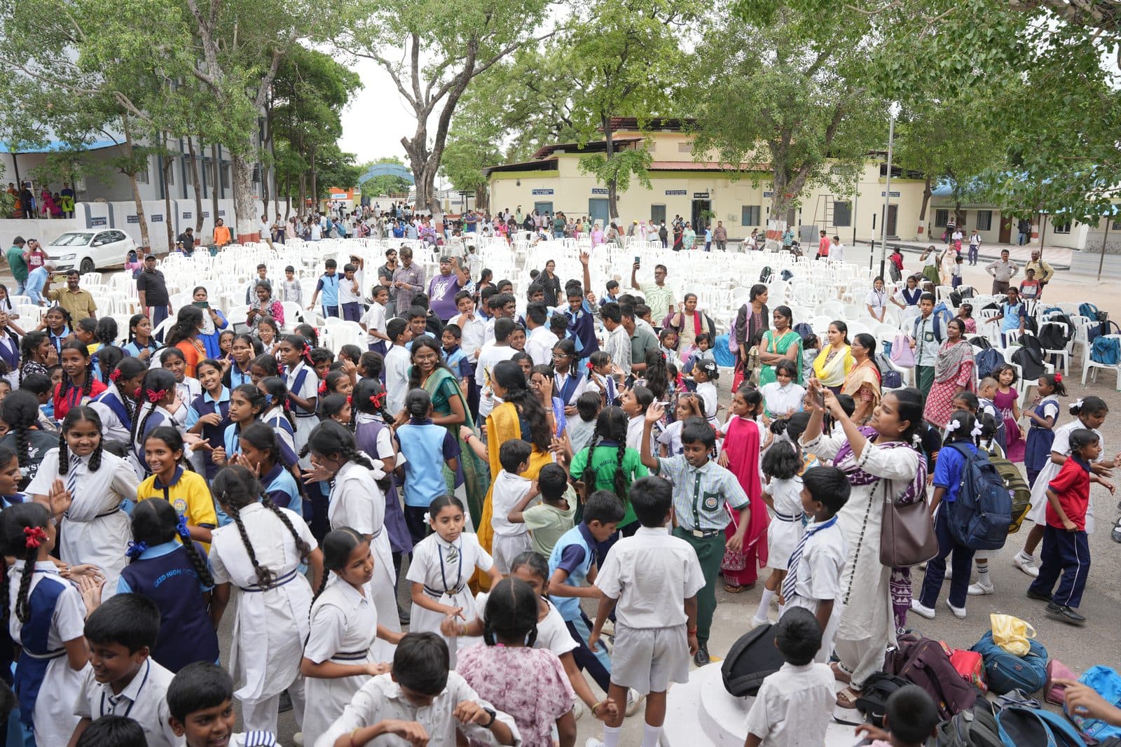 Students dancing together with raised hands during a school celebration